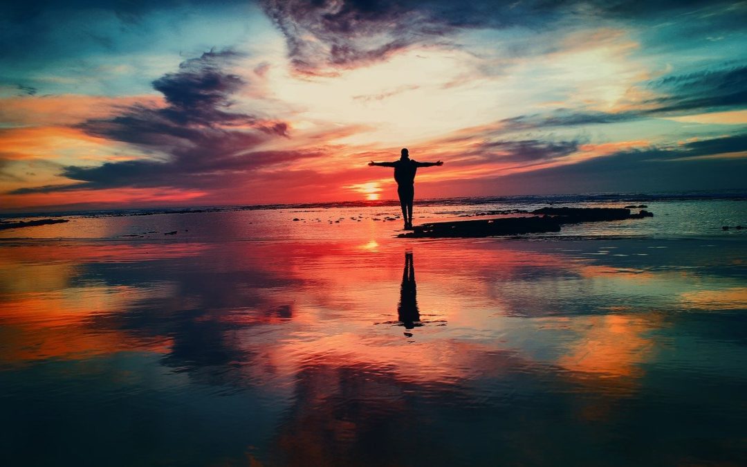 man standing next to ocean