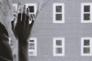 hand on window in rain